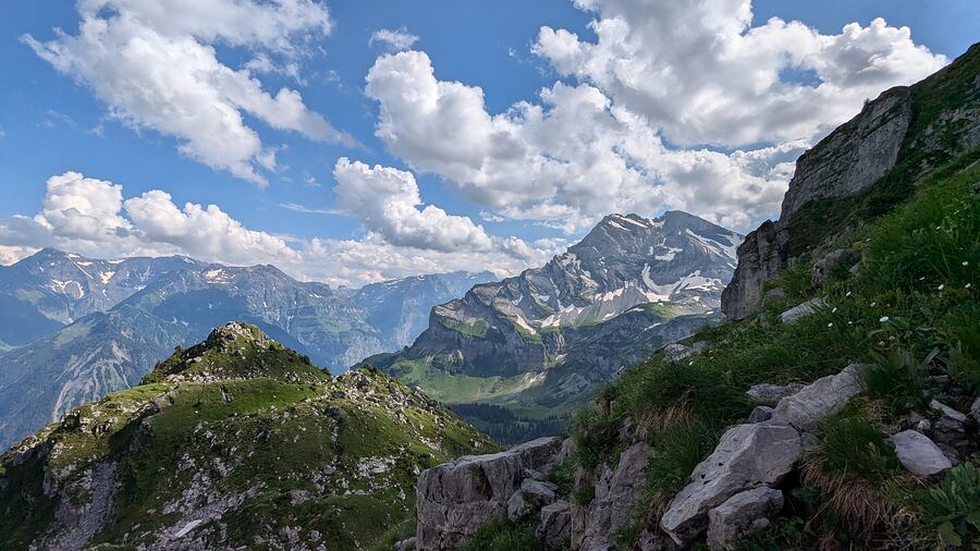 Wide view over an alpine valley from a rocky ridge